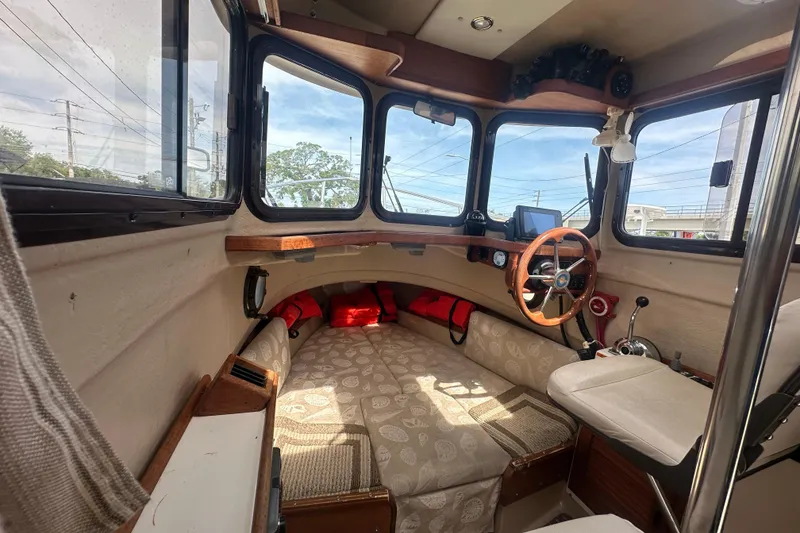 Slide: The Image of 2015 Ranger Tugs R-21 EC interior with helm, seating, and navigation equipment. - 7