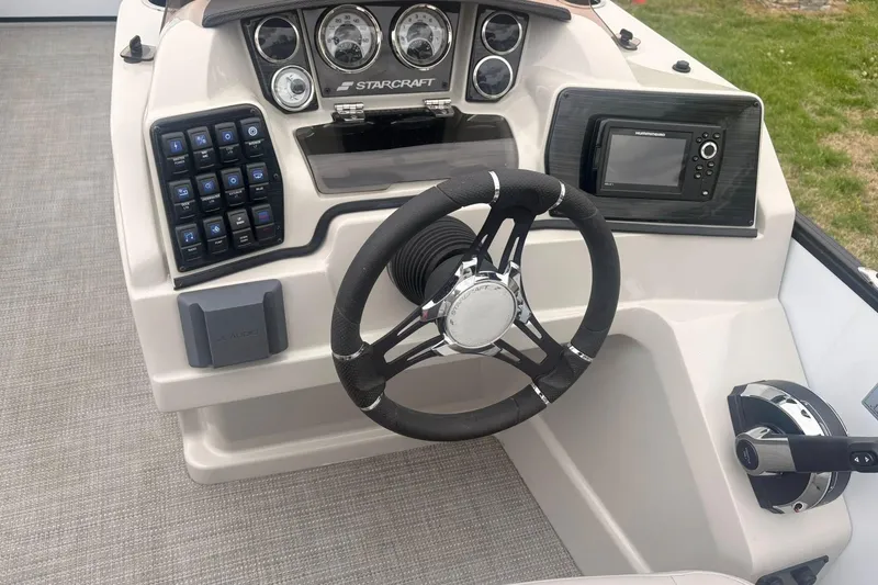 Slide: The Image of Cockpit of 2023 Starcraft SLS 3 boat with steering wheel and control panel. - 3