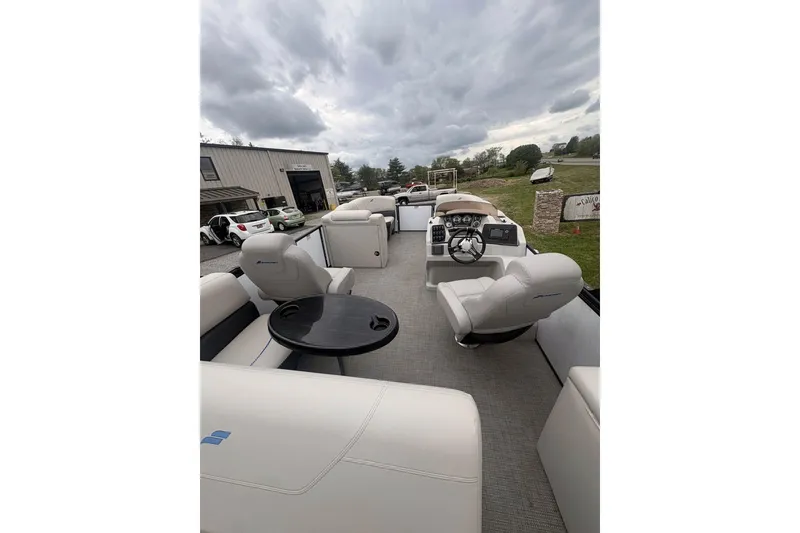 Slide: The Image of 2023 Starcraft SLS 3 pontoon boat interior with plush seating and modern helm. - 4
