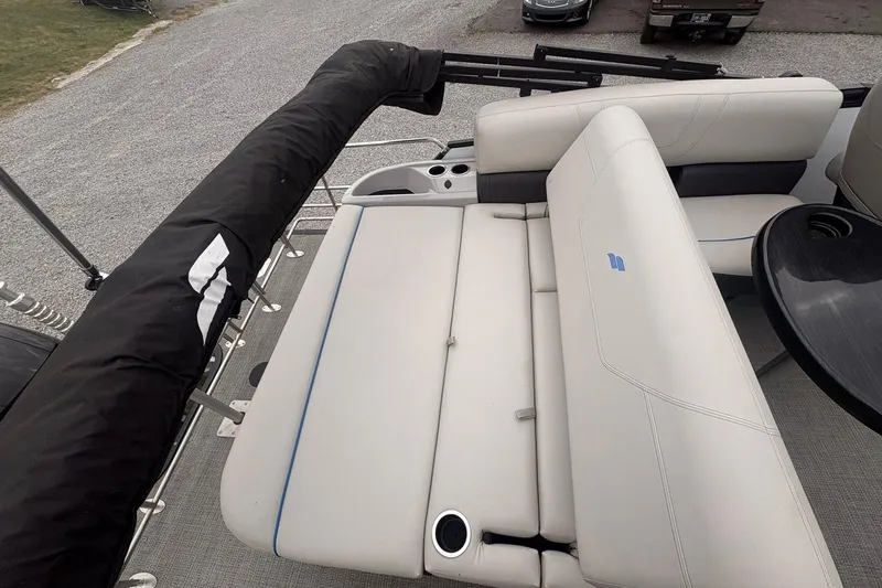 Slide: The Image of 2023 Starcraft SLS 3 boat interior with white seating and cup holders. - 5