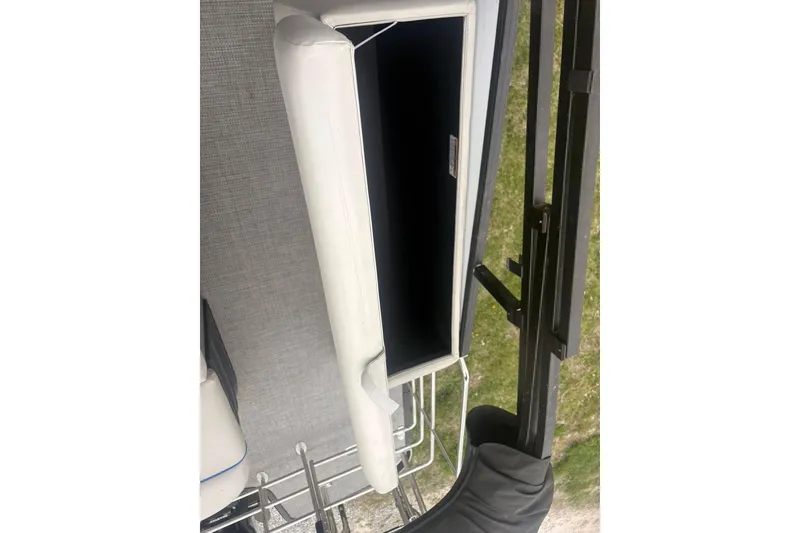 Slide: The Image of 2023 Starcraft SLS 3 boat interior storage compartment with white cushioned lid. - 6