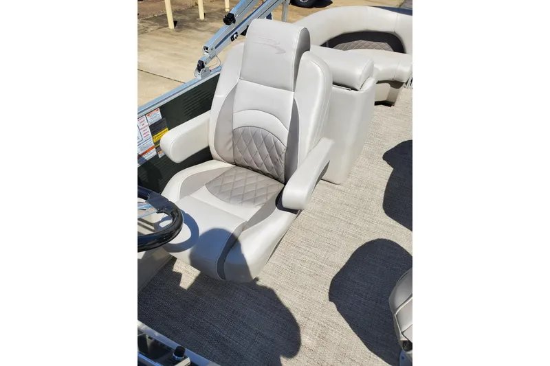 Slide: The Image of 2019 Bennington SX 23 SPDXP boat interior with plush seating and steering wheel. - 11