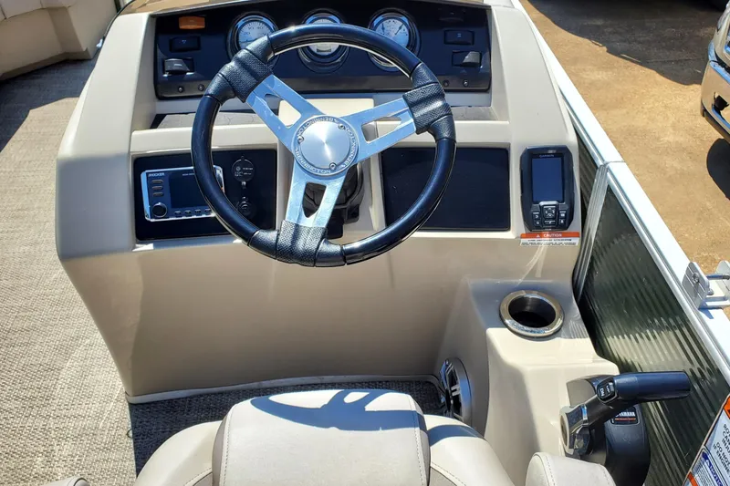 Slide: The Image of 2019 Bennington SX 23 SPDXP boat dashboard with steering wheel and controls. - 13