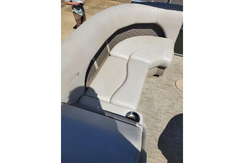 Slide: The Image of 2019 Bennington SX 23 SPDXP boat interior with beige seating and cup holder. - 14