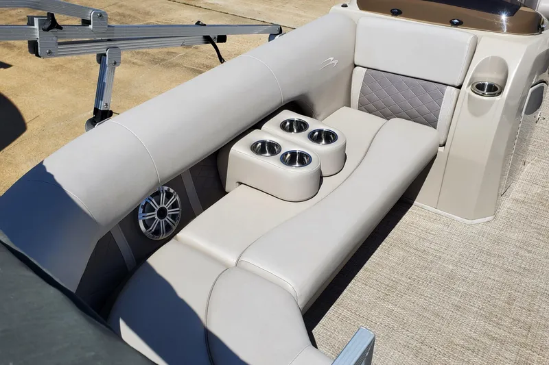 Slide: The Image of 2019 Bennington SX 23 SPDXP boat interior with cushioned seating and cup holders. - 16