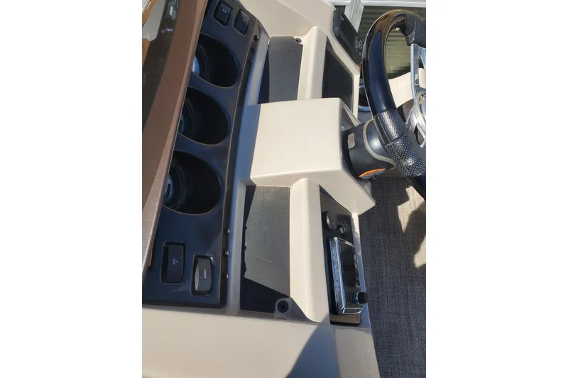 Slide: The Image of 2019 Bennington SX 23 SPDXP dashboard with steering wheel and controls. - 17