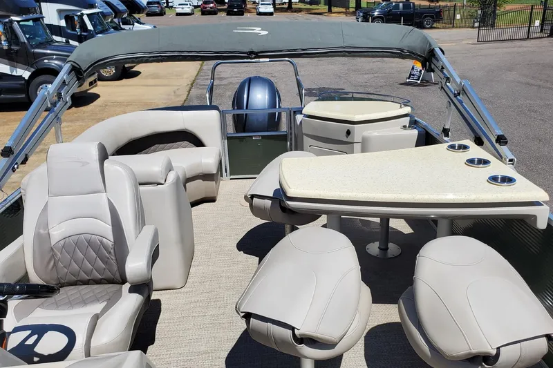 Slide: The Image of 2019 Bennington SX 23 SPDXP pontoon boat interior with seating and table setup. - 18