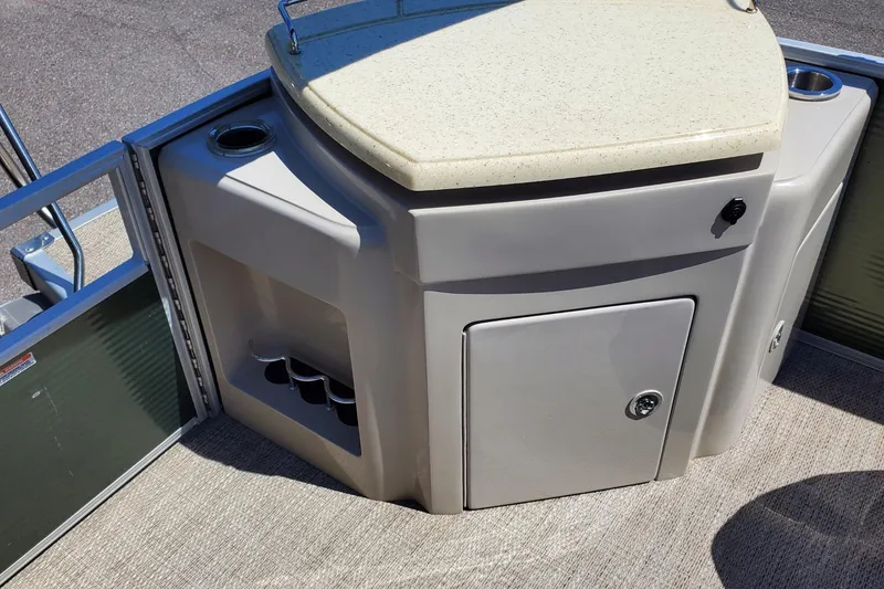 Slide: The Image of 2019 Bennington SX 23 SPDXP boat interior with storage compartment and cup holders. - 19