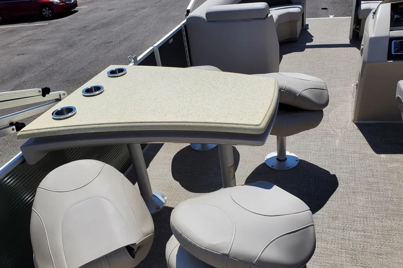 Slide: The Image of 2019 Bennington SX 23 SPDXP boat interior with seating and table featuring cup holders. - 6