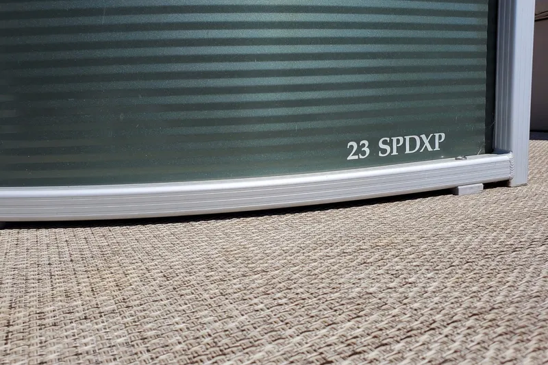 Slide: The Image of 2019 Bennington SX 23 SPDXP pontoon boat detail on textured surface. - 7