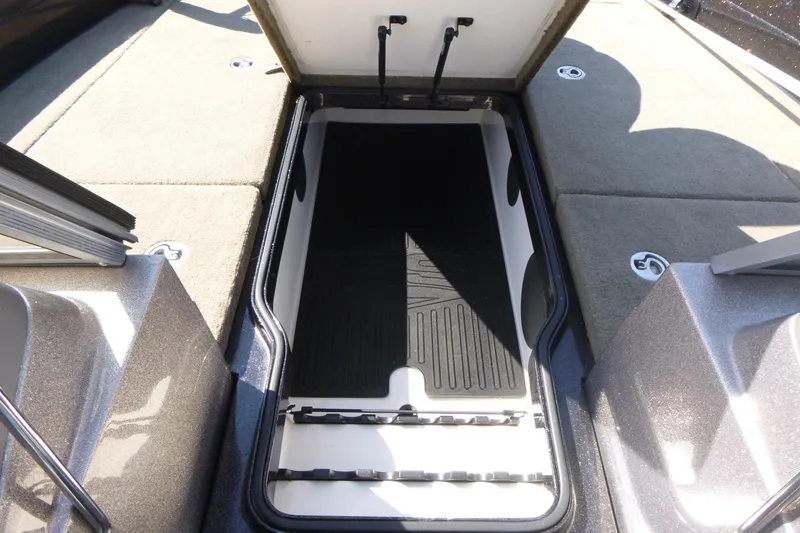 Slide: The Image of Open storage compartment on 2019 Ranger 620FS Fisherman boat, featuring carpeted deck. - 10