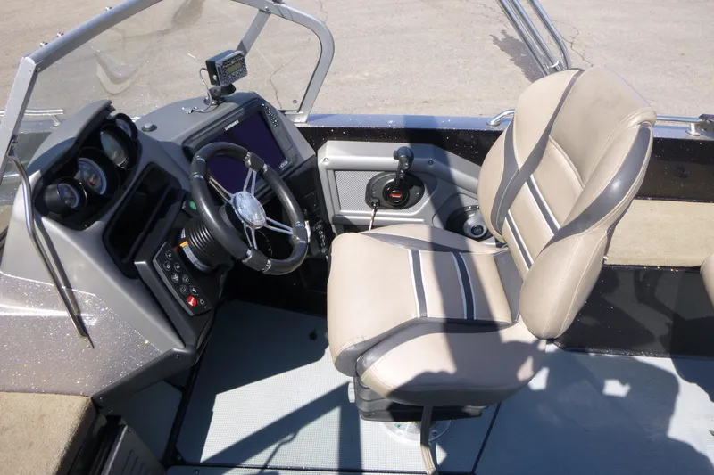 Slide: The Image of 2019 Ranger 620FS Fisherman boat cockpit with steering wheel and control panel. - 11