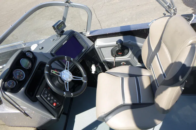 Slide: The Image of 2019 Ranger 620FS Fisherman boat cockpit with steering wheel, gauges, and comfortable seating. - 12