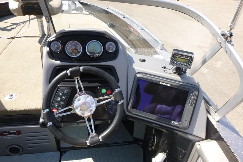 Slide: The Image of 2019 Ranger 620FS Fisherman boat dashboard with steering wheel and Lowrance HDS display. - 13