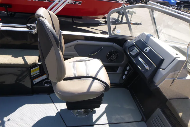 Slide: The Image of 2019 Ranger 620FS Fisherman boat interior with captain's chair and dashboard controls. - 16