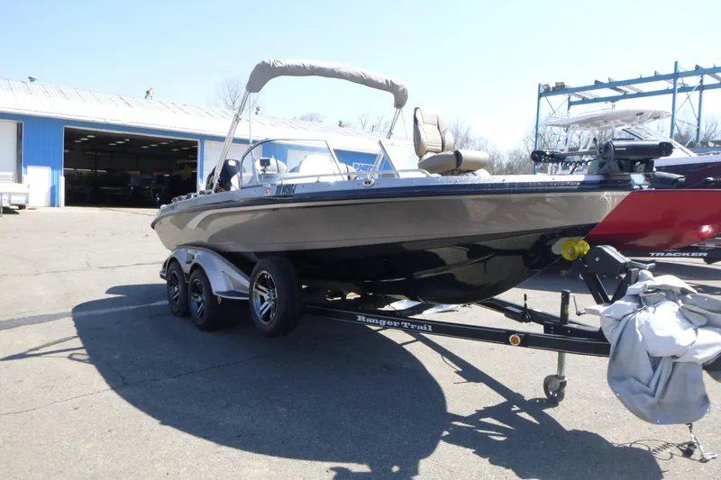 Slide: The Image of 2019 Ranger 620FS Fisherman boat on trailer outside a blue building. - 3