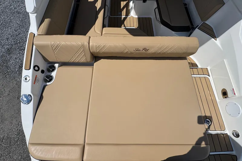Slide: The Image of 2026 Sea Ray SDX 250 Outboard boat interior with tan seating and wood accents. - 11