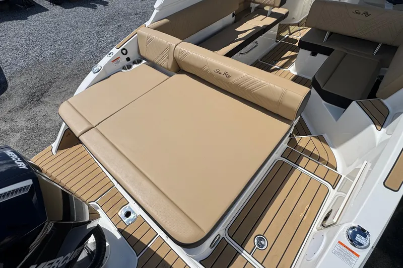 Slide: The Image of 2026 Sea Ray SDX 250 Outboard boat with tan seating and wood-style flooring. - 12