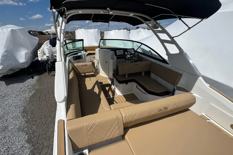 Slide: The Image of 2026 Sea Ray SDX 250 Outboard boat interior with tan seating and modern dashboard. - 13