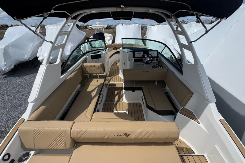 Slide: The Image of 2026 Sea Ray SDX 250 Outboard boat interior with tan seating and modern dashboard. - 14