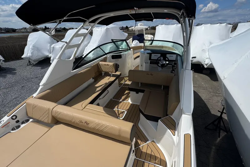Slide: The Image of 2026 Sea Ray SDX 250 Outboard boat interior with tan seating and sleek design. - 15