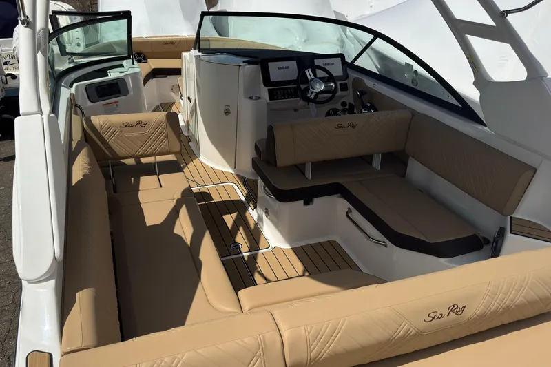 Slide: The Image of Luxurious interior of 2026 Sea Ray SDX 250 Outboard boat with tan seating and modern dashboard. - 16