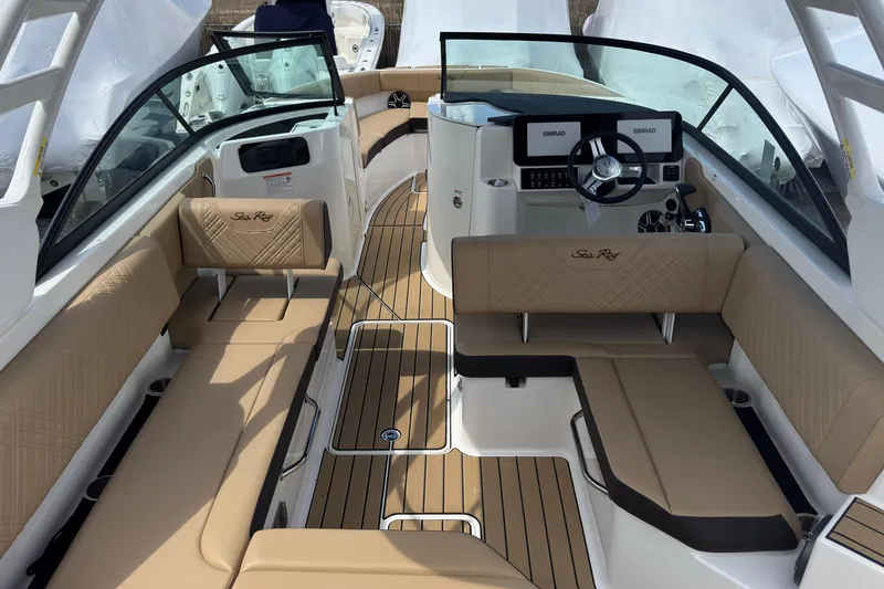 Slide: The Image of 2026 Sea Ray SDX 250 Outboard interior with tan seating and modern dashboard. - 17