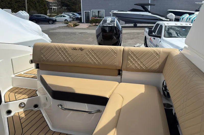 Slide: The Image of 2026 Sea Ray SDX 250 Outboard boat interior with tan leather seating and elegant design. - 20