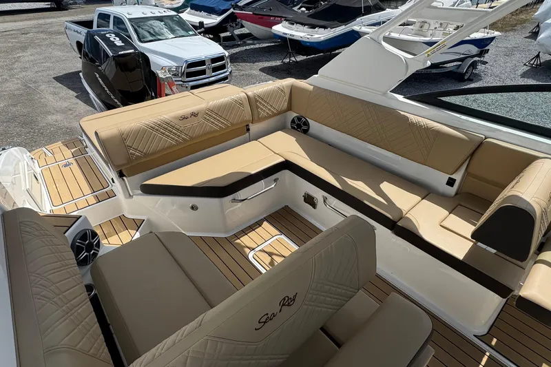 Slide: The Image of 2026 Sea Ray SDX 250 Outboard boat interior with tan seating and wood accents. - 21
