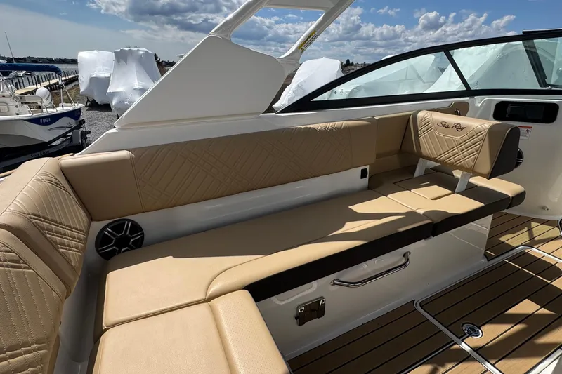 Slide: The Image of Luxurious seating on 2026 Sea Ray SDX 250 Outboard boat, featuring tan upholstery and sleek design. - 22