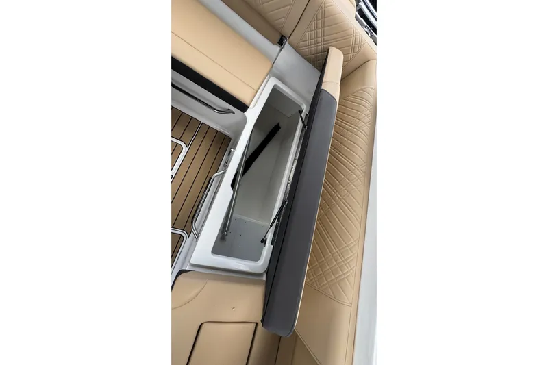 Slide: The Image of 2026 Sea Ray SDX 250 Outboard boat seat storage compartment, beige upholstery. - 23