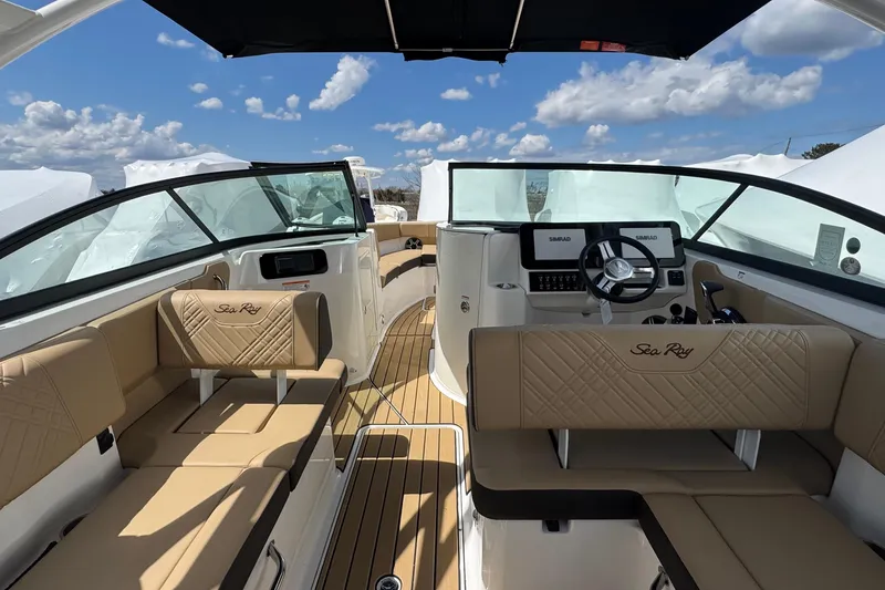 Slide: The Image of 2026 Sea Ray SDX 250 Outboard interior with tan seating and modern dashboard. - 24