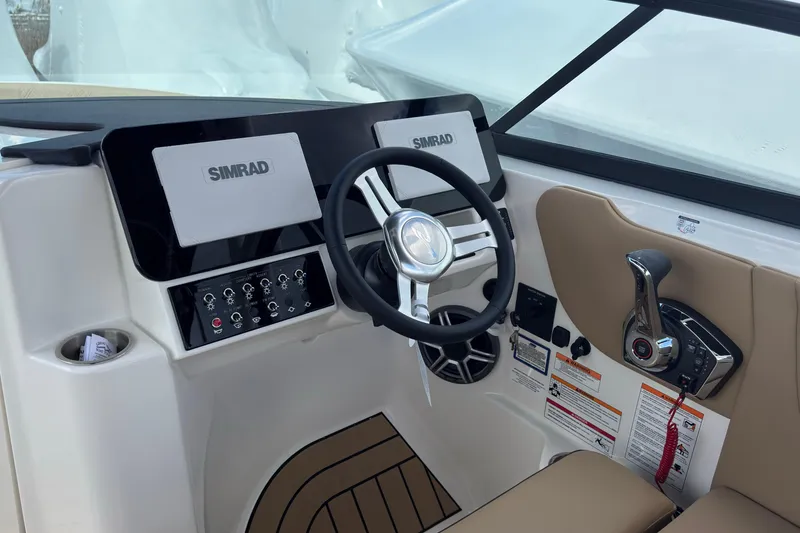 Slide: The Image of Helm of 2026 Sea Ray SDX 250 Outboard with Simrad displays and controls. - 28