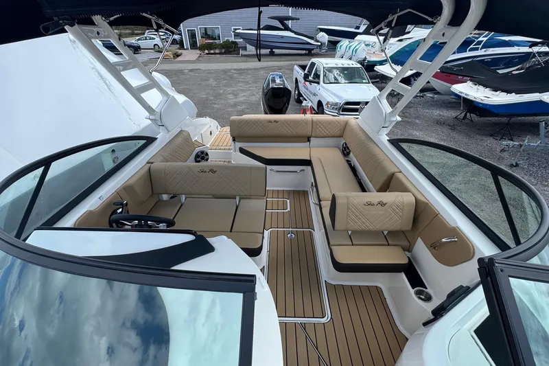 Slide: The Image of 2026 Sea Ray SDX 250 Outboard boat interior with tan seating and sleek design. - 30