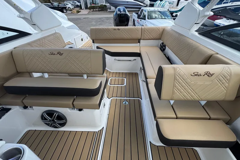 Slide: The Image of Luxurious interior of 2026 Sea Ray SDX 250 Outboard with tan seating and wood flooring. - 31