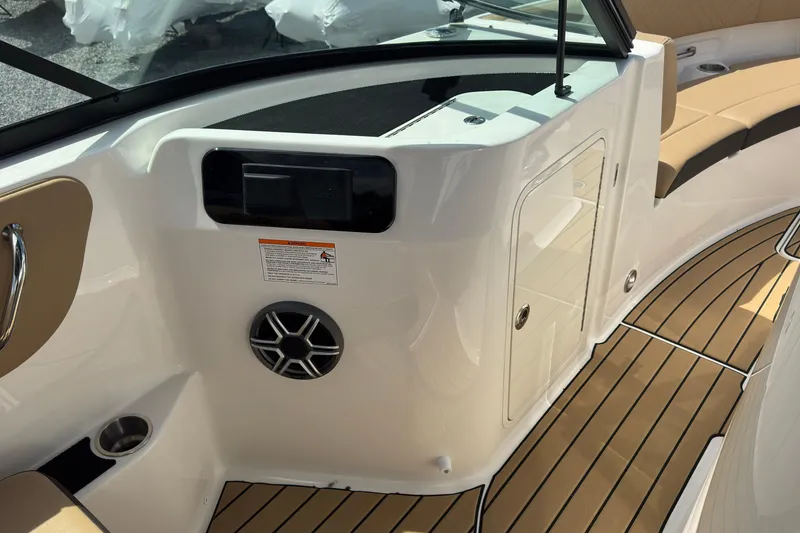 Slide: The Image of 2026 Sea Ray SDX 250 Outboard interior with tan seating and teak-style flooring. - 33