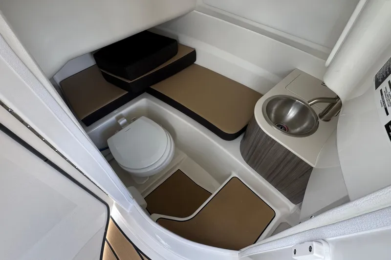 Slide: The Image of 2026 Sea Ray SDX 250 Outboard interior with toilet and sink, featuring modern design. - 36