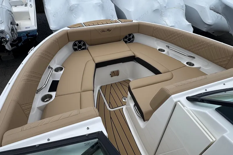 Slide: The Image of 2026 Sea Ray SDX 250 Outboard boat interior with tan seating and wood accents. - 38