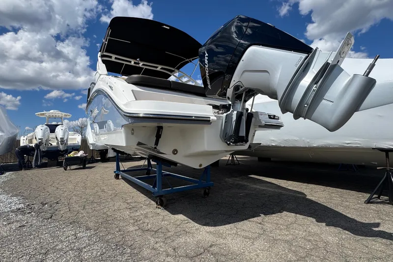 Slide: The Image of 2026 Sea Ray SDX 250 Outboard boat on stand, showcasing powerful engine and sleek design. - 4
