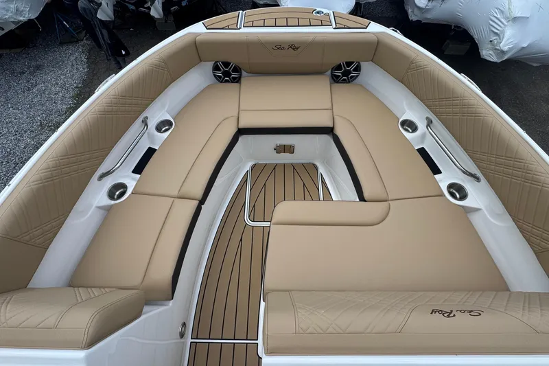 Slide: The Image of 2026 Sea Ray SDX 250 Outboard boat interior with tan seating and wood accents. - 42