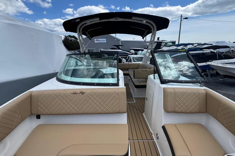 Slide: The Image of 2026 Sea Ray SDX 250 Outboard boat interior with tan seating and sleek design. - 44