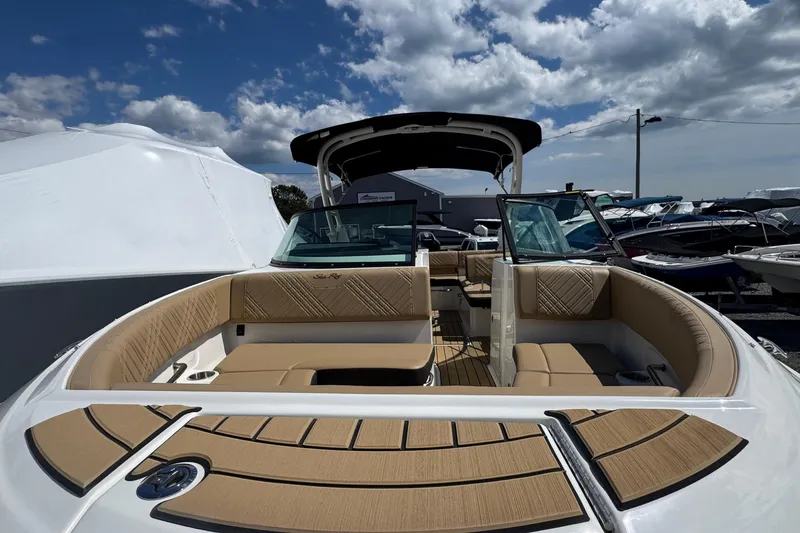 Slide: The Image of 2026 Sea Ray SDX 250 Outboard boat with spacious seating under a partly cloudy sky. - 46