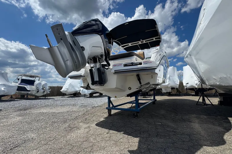 Slide: The Image of 2026 Sea Ray SDX 250 Outboard boat displayed outdoors under a partly cloudy sky. - 6