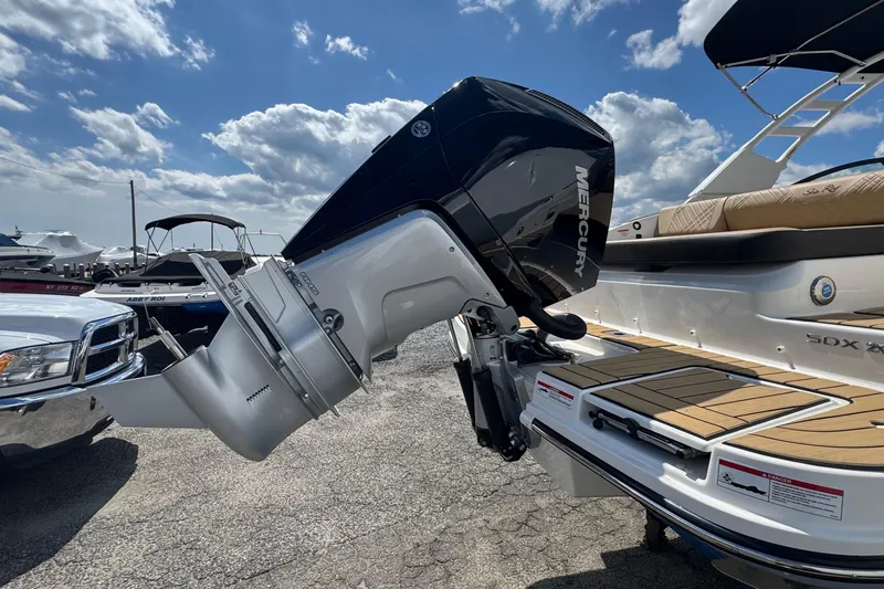 Slide: The Image of 2026 Sea Ray SDX 250 Outboard with Mercury engine, docked under a blue sky. - 7
