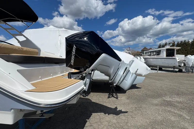 Slide: The Image of 2026 Sea Ray SDX 250 Outboard boat with Mercury engine under a clear blue sky. - 8
