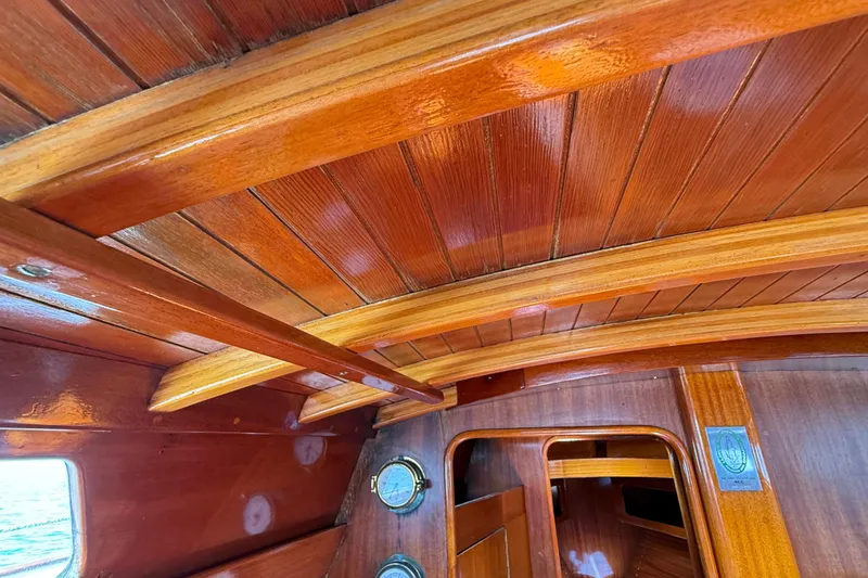 Slide: The Image of Interior of 1986 Vindo 45 sailboat with polished wooden ceiling and portholes. - 16