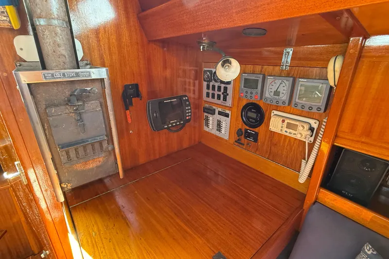 Slide: The Image of Navigation station of 1986 Vindo 45 yacht with control panels and vintage stove. - 18