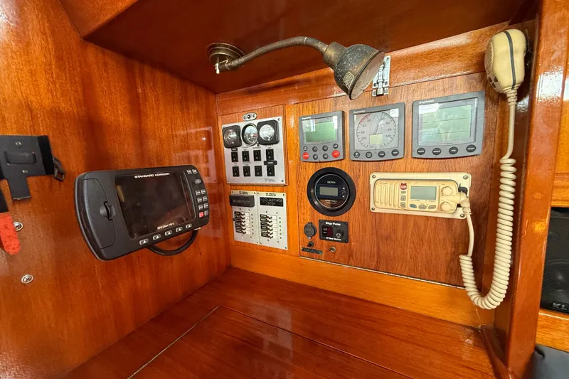 Slide: The Image of Control panel of a 1986 Vindo 45 sailboat with navigation instruments and communication devices. - 19