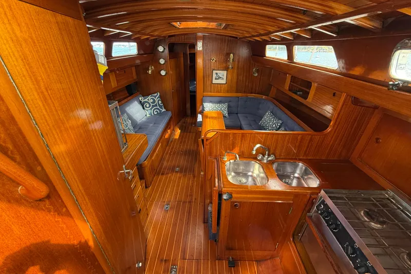 Slide: The Image of Interior of 1986 Vindo 45 sailboat with wooden finish and cozy seating area. - 24