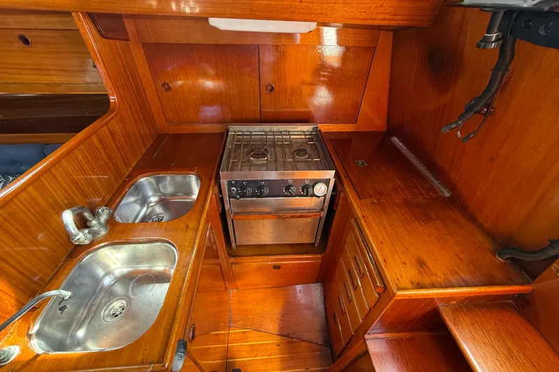 Slide: The Image of Wooden interior of 1986 Vindo 45 yacht kitchen with stove and dual sinks. - 25